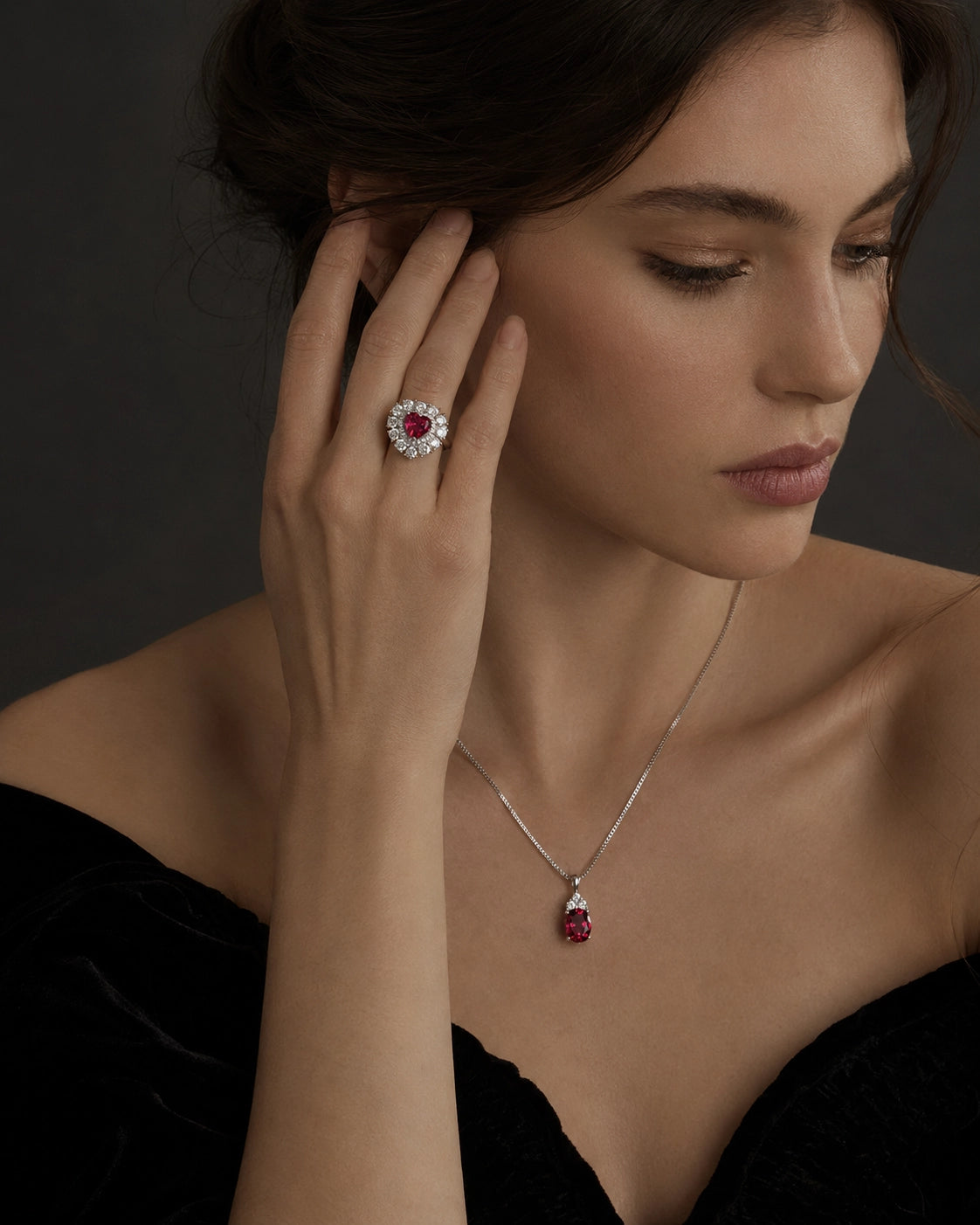 Elegant woman wearing the Dellyrica heart-shaped ruby ring and Starlit Garden lab-grown ruby necklace.