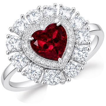 Heart-shaped ruby halo engagement ring with sparkling white stones and polished white metal on a white background
