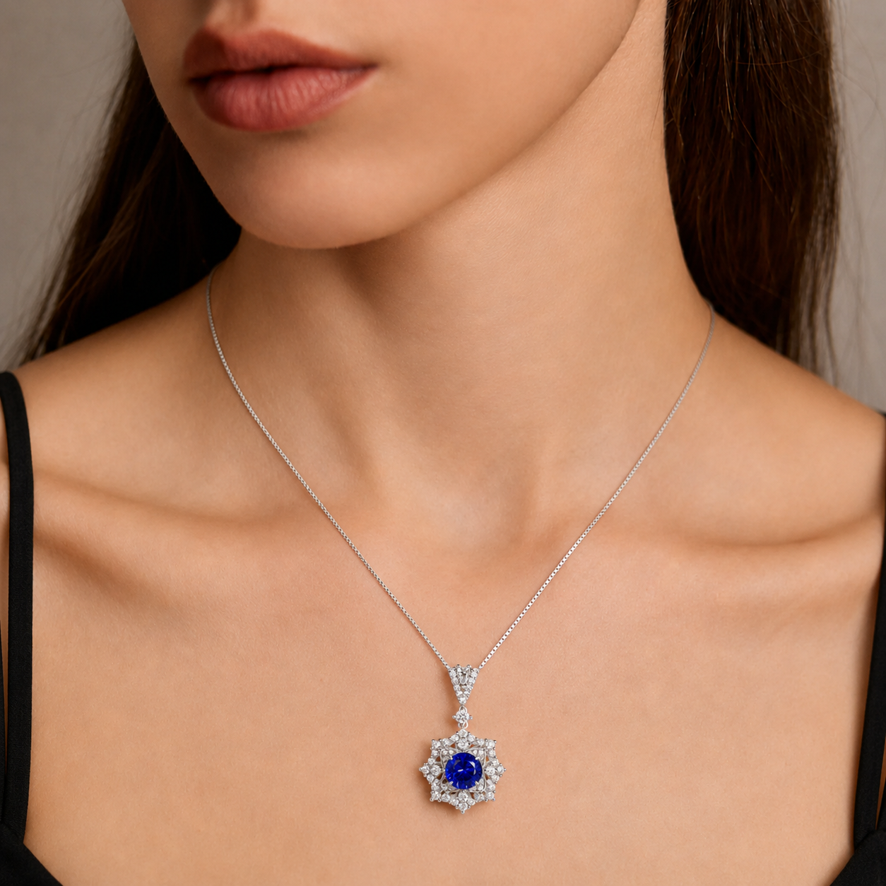 Close-up of Ariadne’s Celestial Crown blue sapphire pendant necklace worn on a woman
