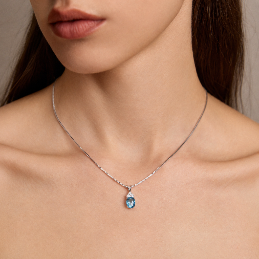 Close-up of model wearing Starlit Garden aquamarine blue spinel necklace with moissanite accents