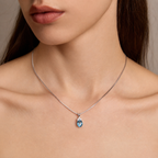Close-up of model wearing Starlit Garden aquamarine blue spinel necklace with moissanite accents