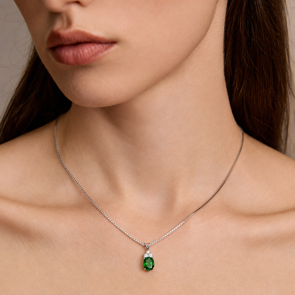 Close-up of model wearing Starlit Garden emerald necklace with moissanite accents