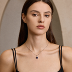 Model wearing Starlit Garden royal blue sapphire necklace with moissanite accents
