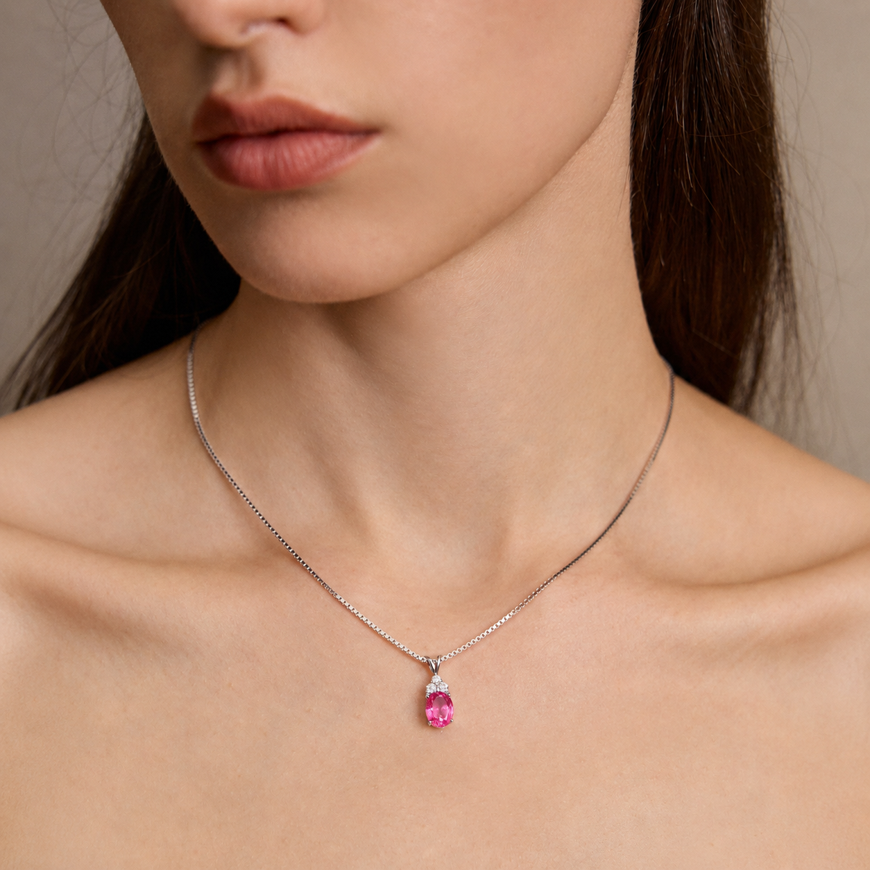Close-up of model wearing Starlit Garden vivid pink sapphire necklace with moissanite accents