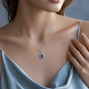 Woman wearing the Dellyrica Seafoam Reverie royal blue sapphire necklace