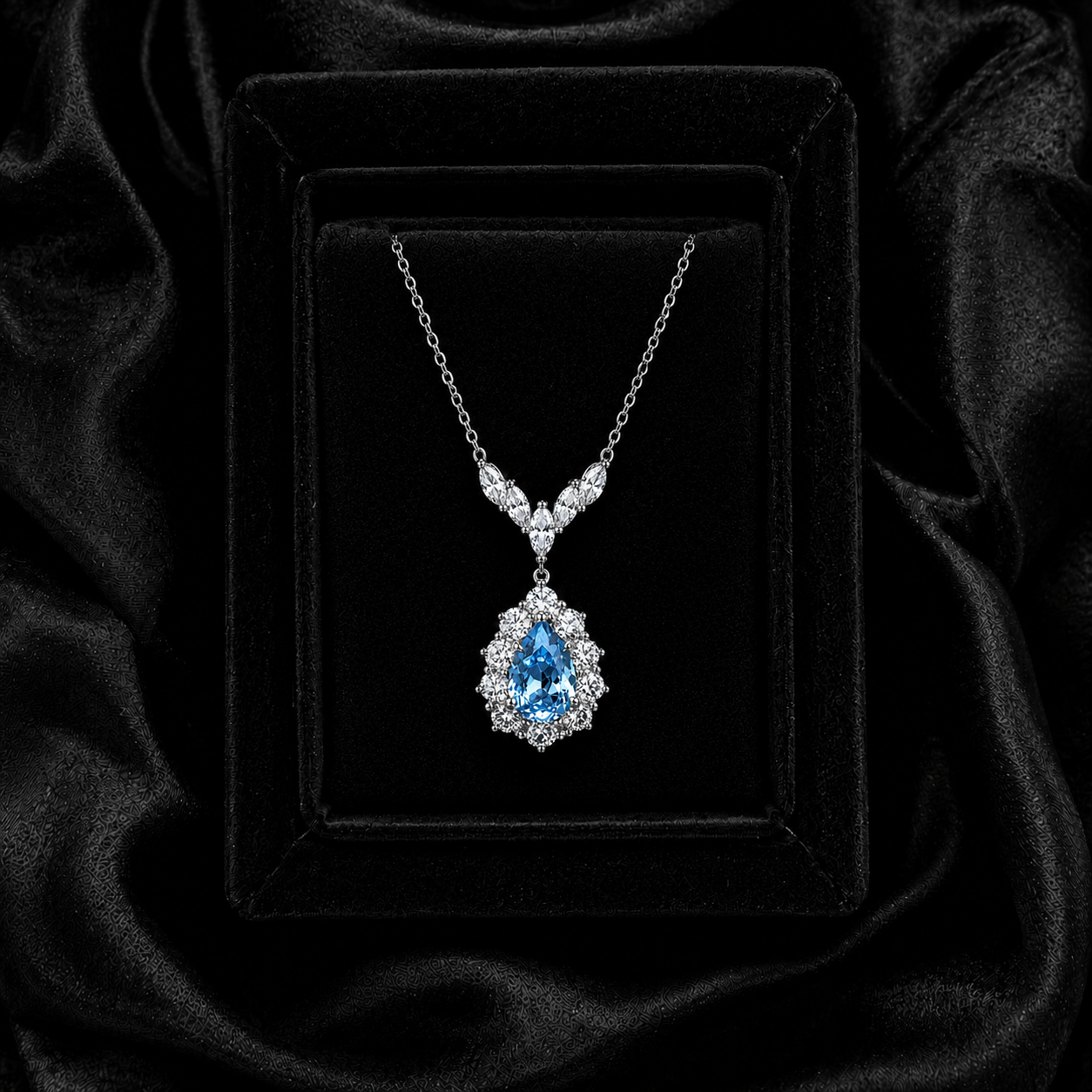 Seafoam Reverie pear-cut sea-blue spinel necklace displayed on black velvet