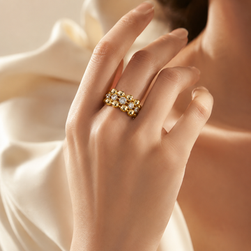 Model wearing a vintage-inspired three-row gold beaded cubic zirconia statement ring