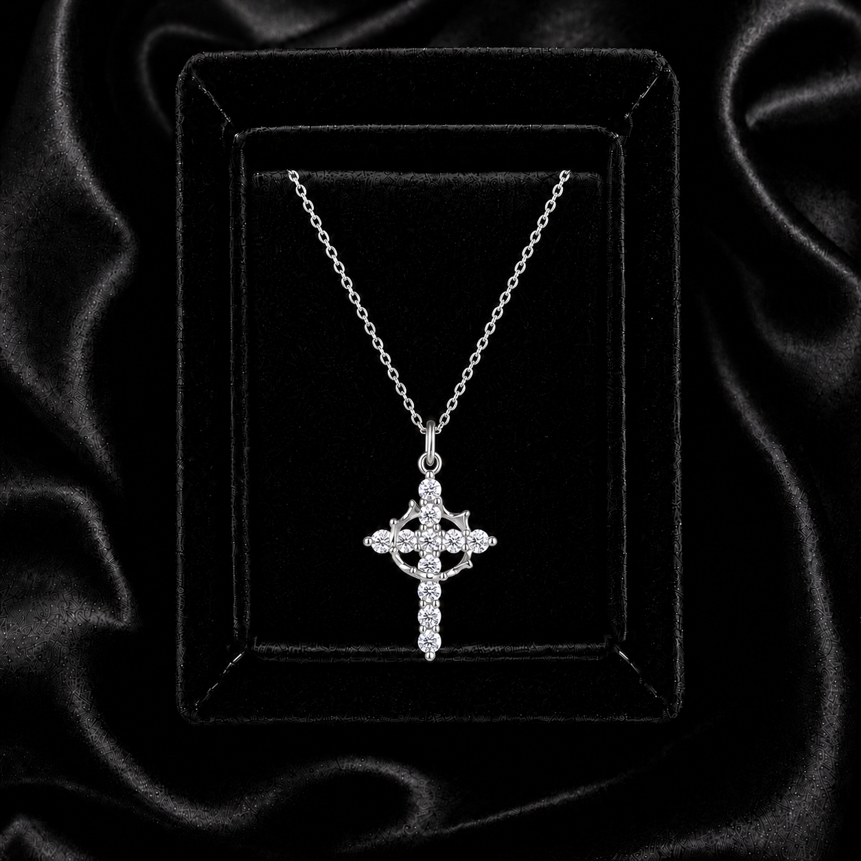Moissanite crown of thorns cross necklace displayed on black velvet
