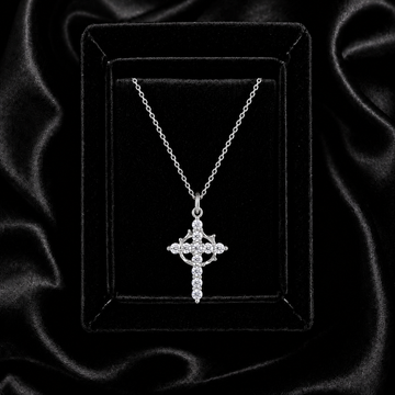 Moissanite crown of thorns cross necklace displayed on black velvet