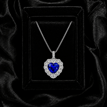 Heart of the Ocean royal blue sapphire heart necklace displayed in an elegant black jewelry box