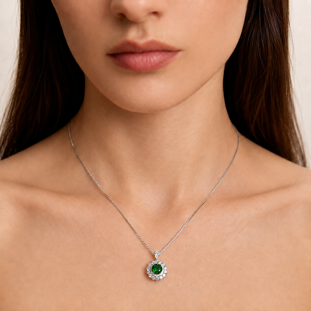 Model wearing the Moon Halo Emerald Necklace with a vivid green lab-grown emerald and moissanite halo pendant