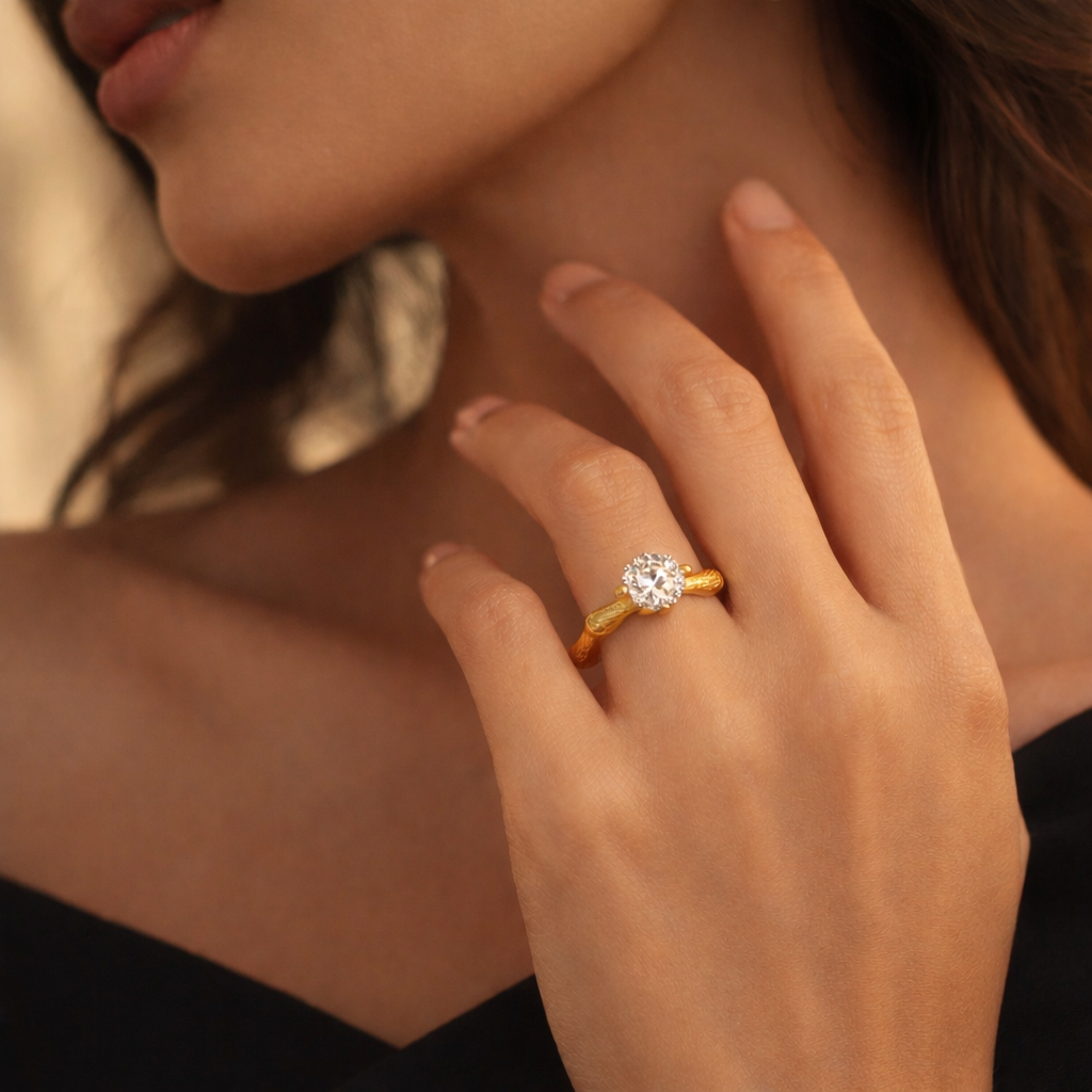 Close-up of Eve’s Embrace D-color moissanite solitaire ring worn on hand in heavy 18K gold plated 925 sterling silver