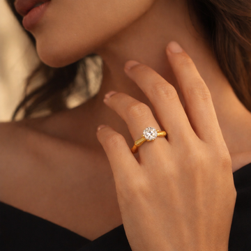 Close-up of Eve’s Embrace D-color moissanite solitaire ring worn on hand in heavy 18K gold plated 925 sterling silver