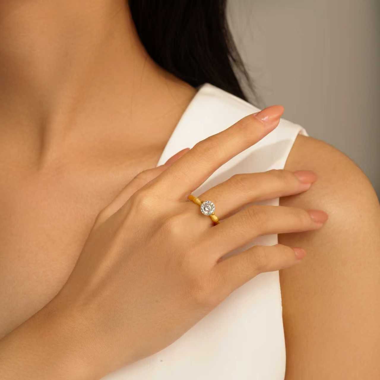 Model wearing Eve’s Embrace D-color moissanite solitaire ring in heavy 18K gold plated 925 sterling silver