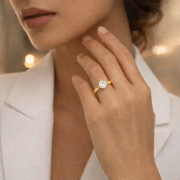 Model wearing Eve’s Embrace D-color moissanite solitaire ring in heavy 18K gold plated 925 sterling silver