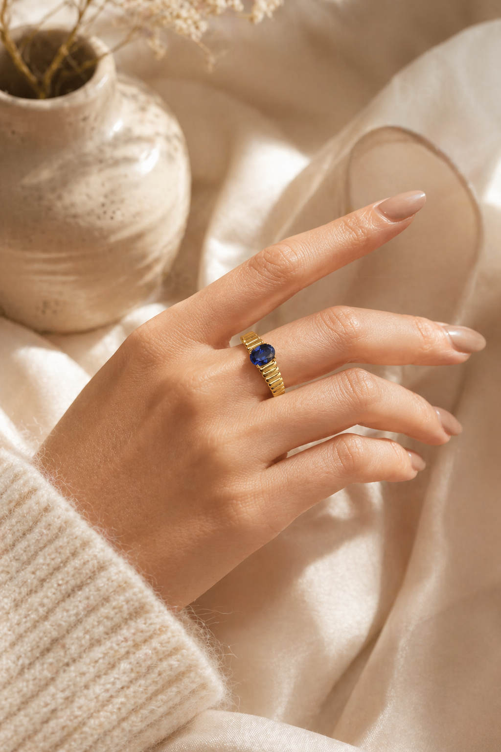 Love Ladder oval lab-grown blue sapphire ring worn on hand in heavy 18K gold plated 925 sterling silver