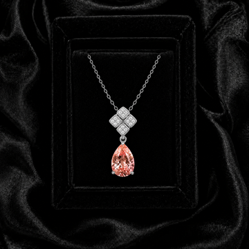 Celestial Bloom padparadscha sapphire necklace displayed in a black velvet jewelry box with elegant luxury lighting