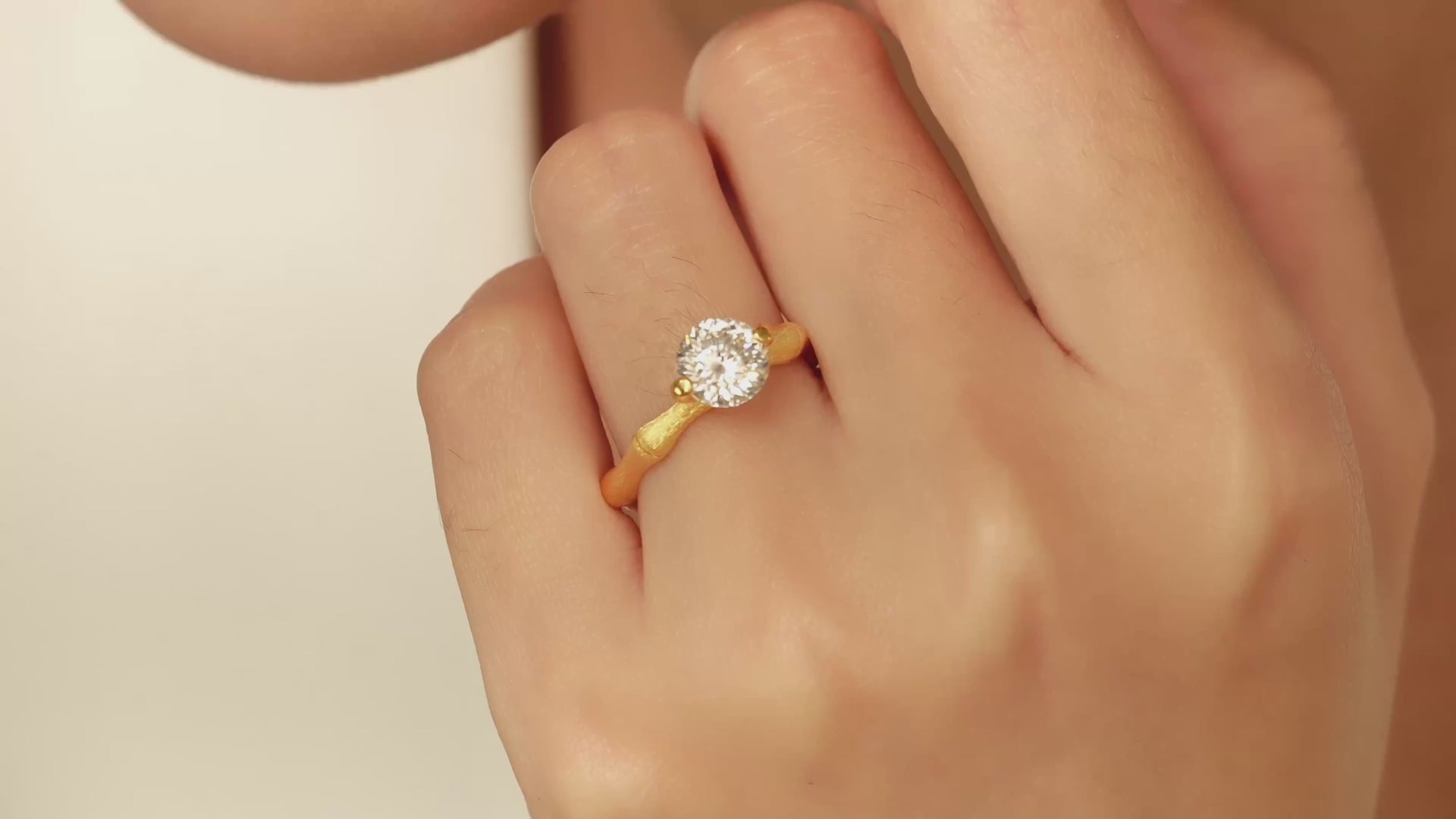 Video of Eve’s Embrace D-color moissanite solitaire ring worn on hand in heavy 18K gold plated 925 sterling silver