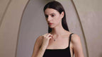 Model wearing Starlit Garden royal blue sapphire necklace with moissanite accents