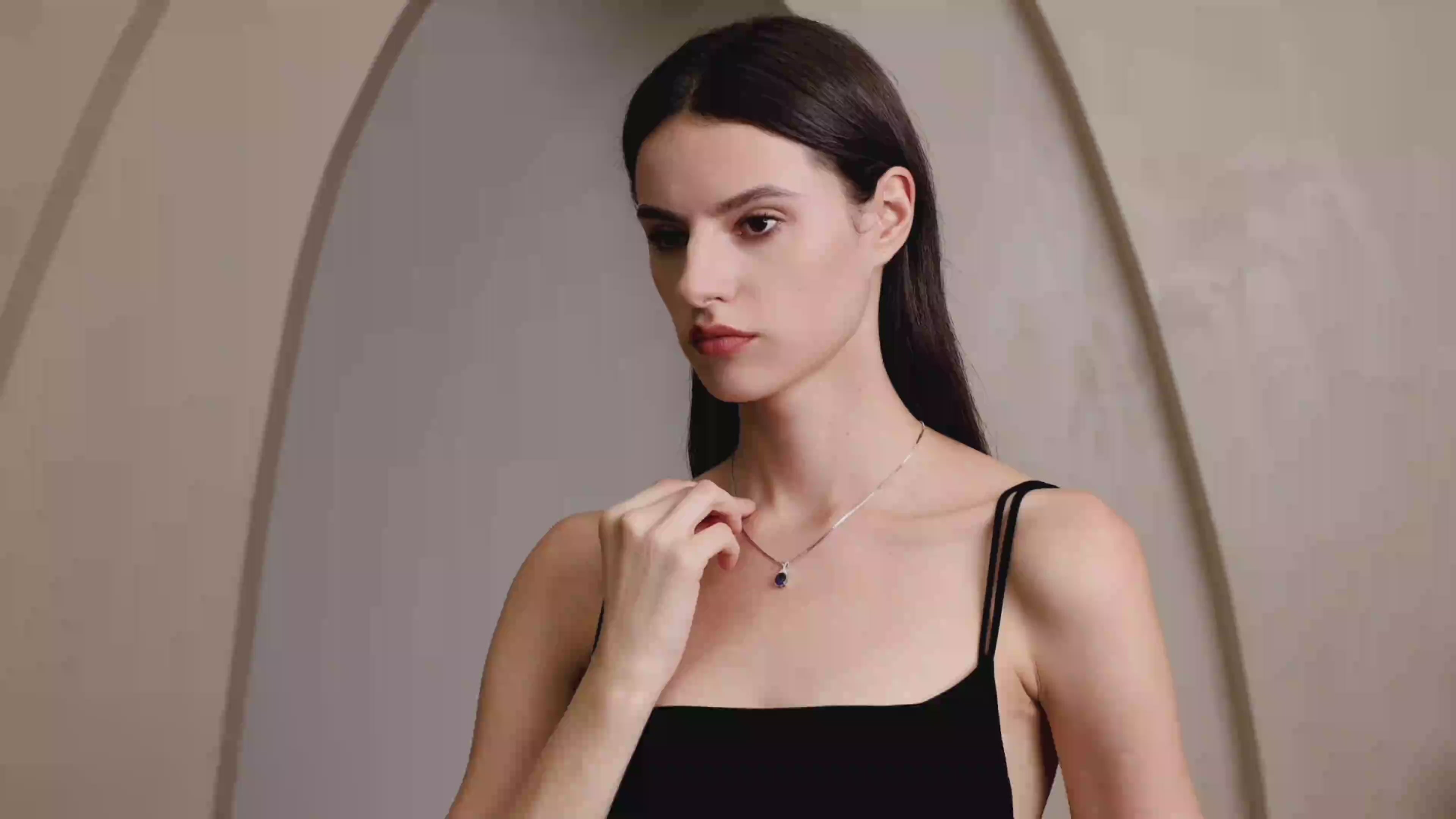 Model wearing Starlit Garden royal blue sapphire necklace with moissanite accents