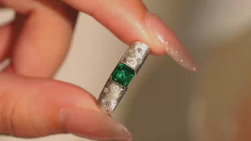 Video close-up of Starburst lab-grown emerald promise ring with D-color moissanite accents in rhodium-plated 925 sterling silver