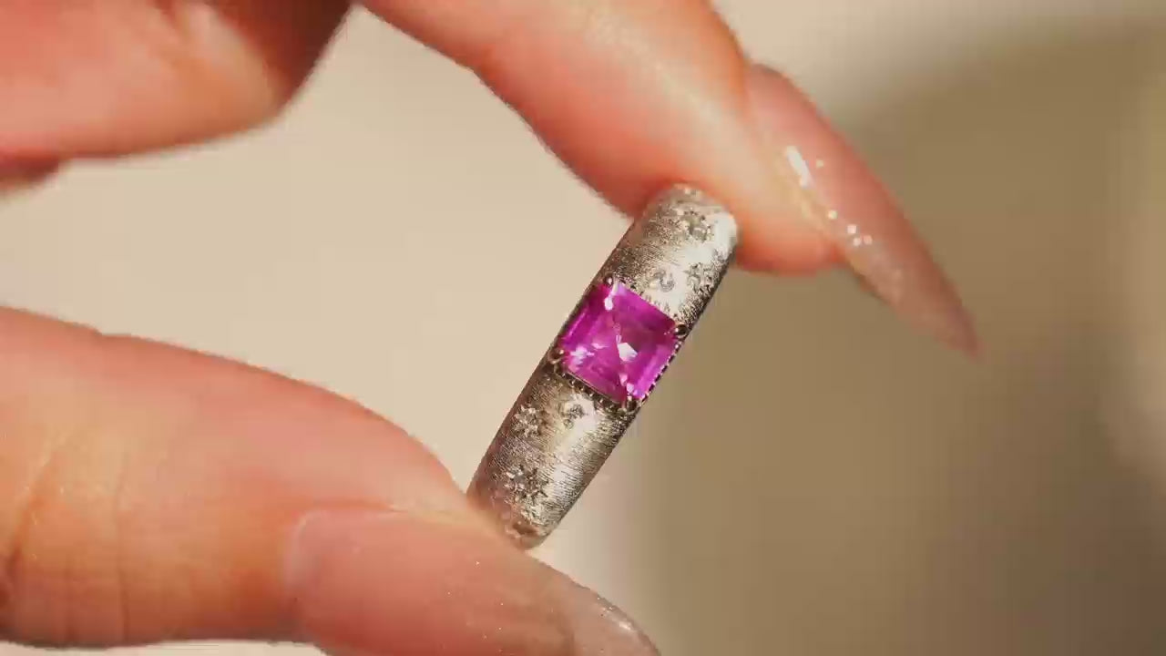 Video close-up of Starburst lab-grown pink sapphire promise ring with D-color moissanite accents in rhodium-plated 925 sterling silver