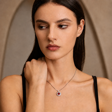 Model styling the Moon Halo Ruby Necklace with a delicate silver chain and ruby halo pendant