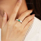 Starburst lab-grown emerald promise ring with D-color moissanite accents worn on hand in rhodium-plated 925 sterling silver