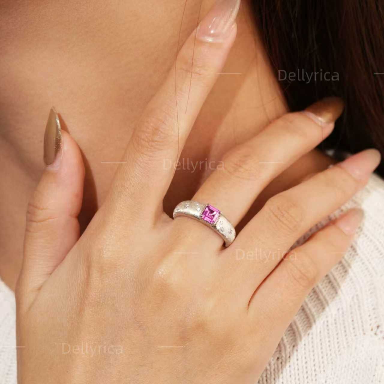 Starburst lab-grown pink sapphire promise ring with D-color moissanite accents worn on hand in rhodium-plated 925 sterling silver