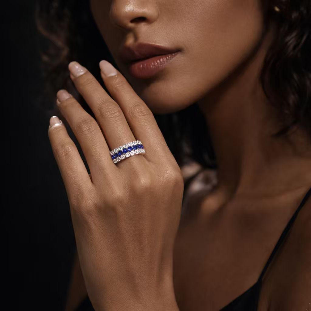 Model wearing a three-row lab-grown blue sapphire and moissanite ring in 925 sterling silver