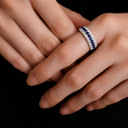 Close-up hand wearing the Blue Sapphire & Moissanite Curved Band Ring, showing the curved band fit and royal blue sapphire details.